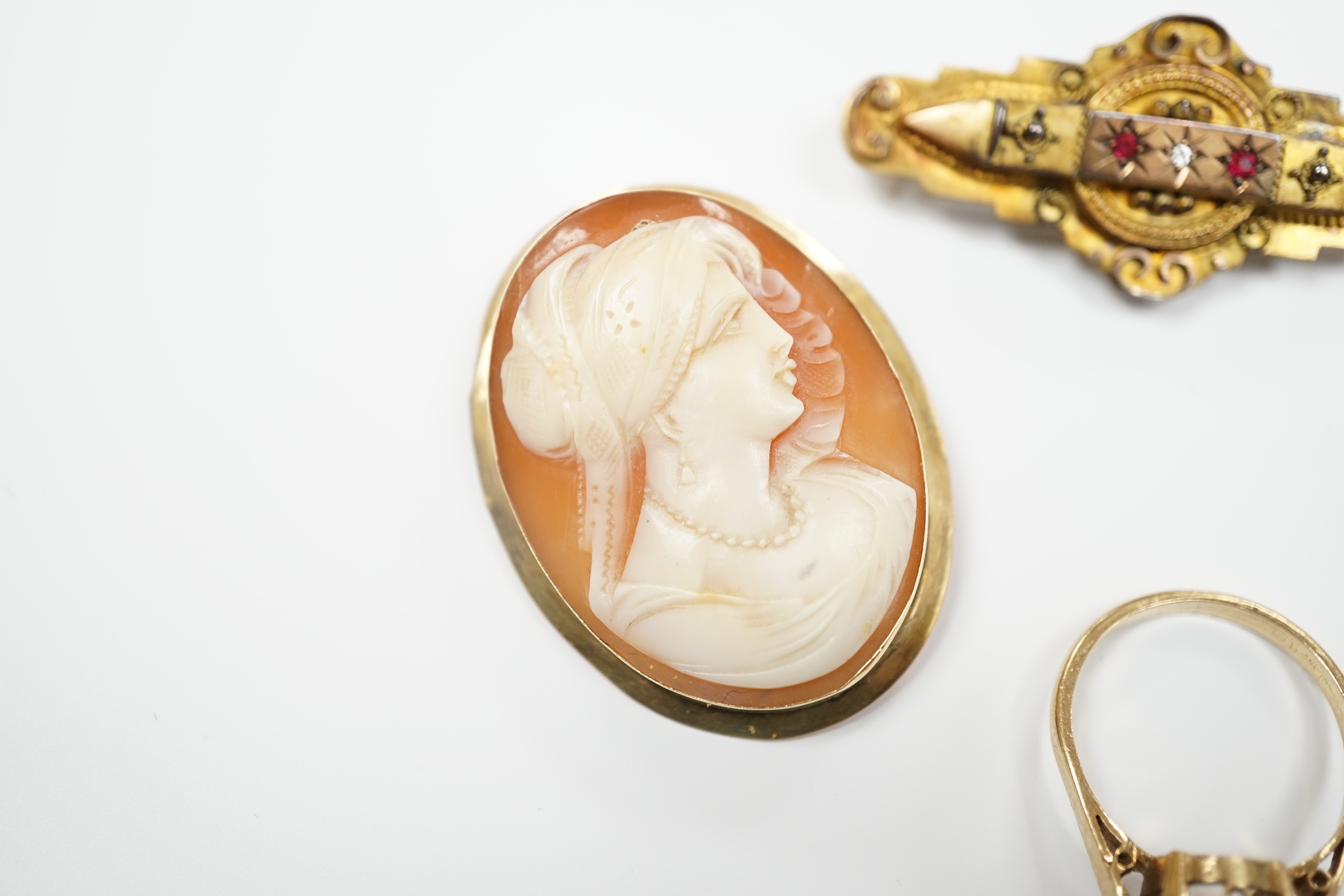 Two 9ct mounted oval cameo shell brooches, largest 38mm, a 9ct and gem set ring and a 9ct gold and gem set bar brooch.